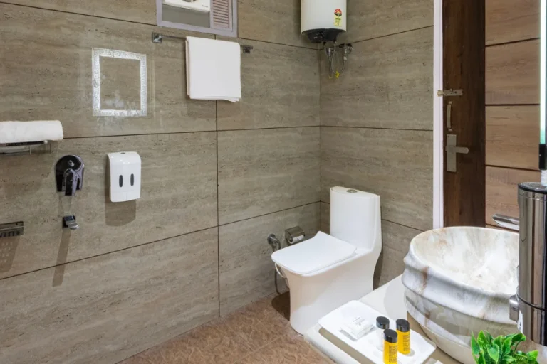 Modern bathroom with marble sink, essential toiletries, and contemporary design at Farmville, Kasauli
