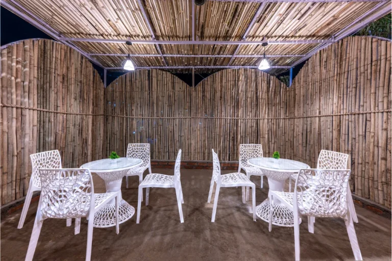 Elegant dining area in Farm Suite at the best resort in Kasauli with bamboo decor and modern seating.