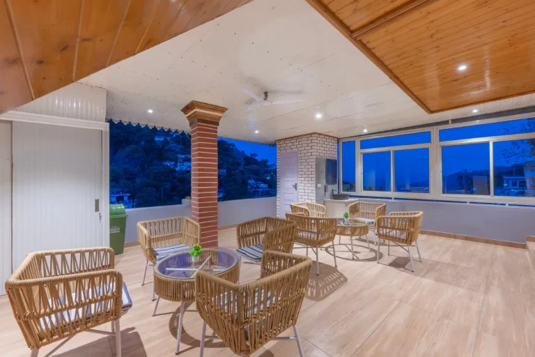 Family-friendly villa balcony in Kasauli with comfortable outdoor seating and breathtaking views